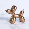 A golden, organic-shaped resin sculpture resembling a dog, shown with dimensions.