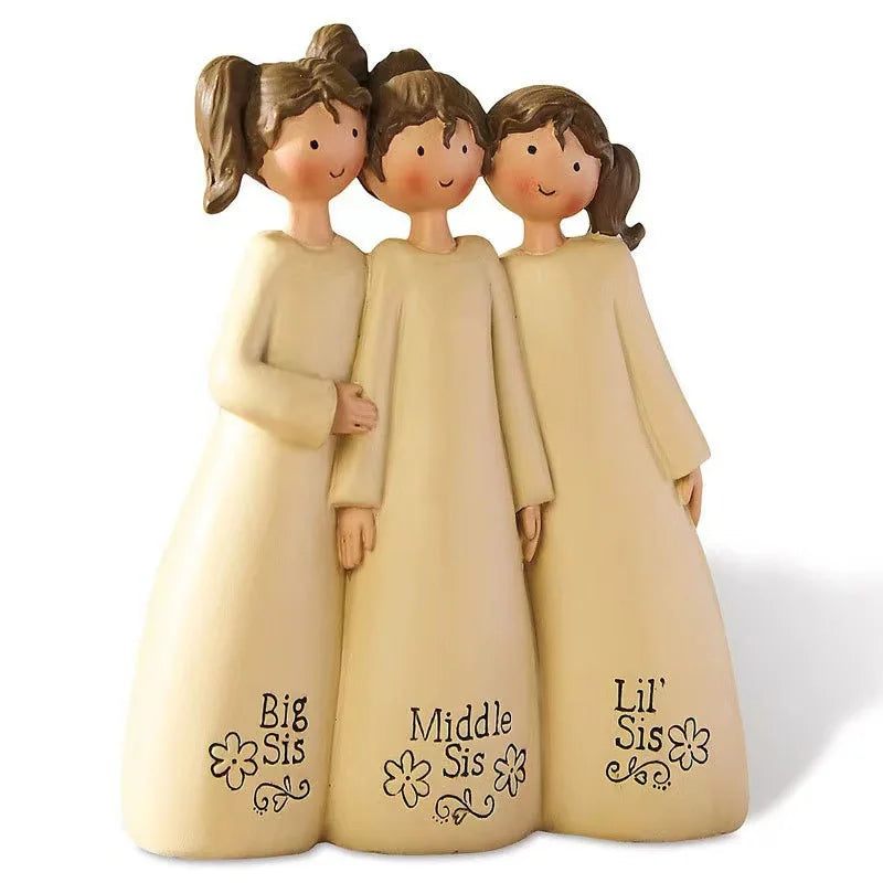 Three ceramic angel friendship statues in beige and cream colors standing side by side