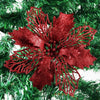 Red glittery silk artificial Christmas flowers with gold sparkle finish on a green pine branch
