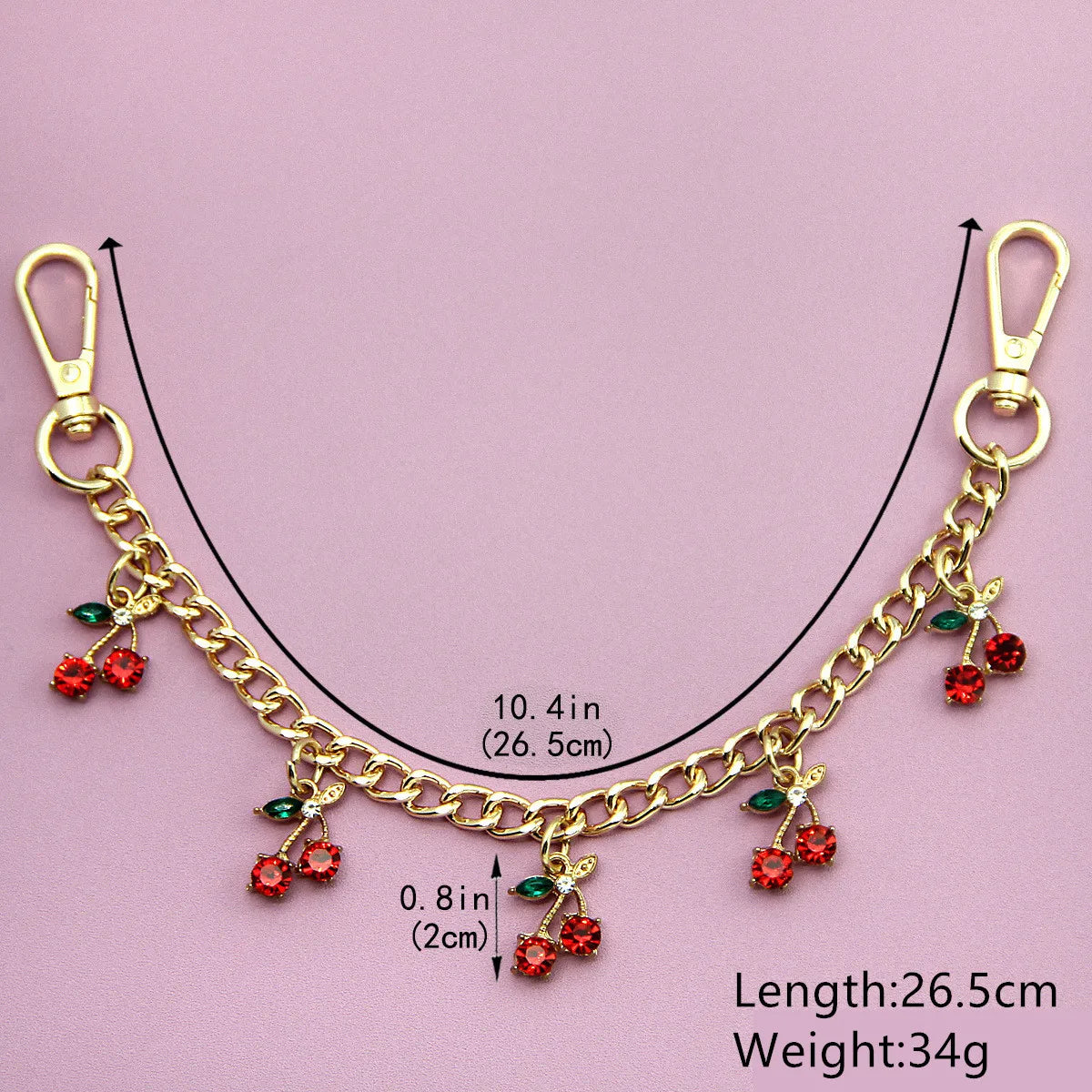 Gold chain necklace featuring red cherry charms and glass stones, measuring 26.5 cm long and weighing 34g.