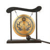 A bronze Feng Shui Zen table gong featuring dragon and Taiji symbols mounted on a dark wooden stand.