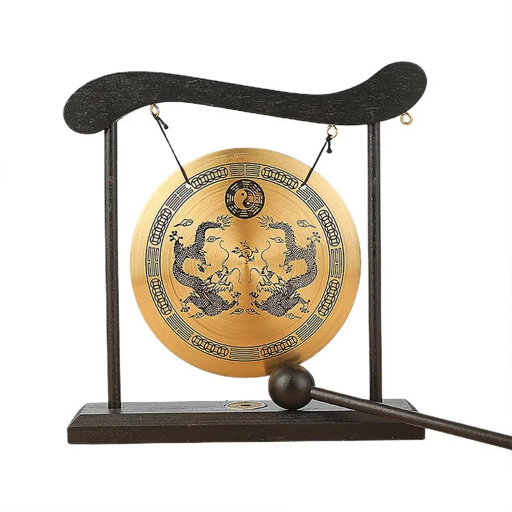 A bronze Feng Shui Zen table gong featuring dragon and Taiji symbols mounted on a dark wooden stand.