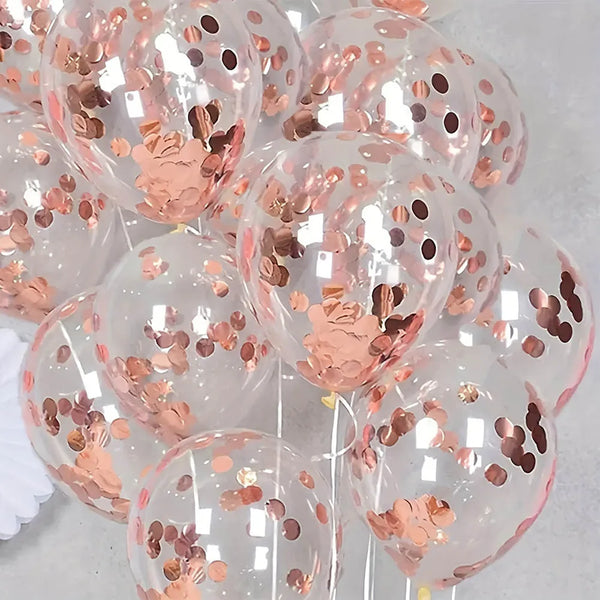 A collection of clear balloons filled with pink liquid and decorated with rose gold sequins for party decor.