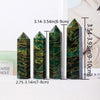 A set of natural emerald crystal point healing wands displayed on a white surface.