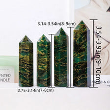 A set of natural emerald crystal point healing wands displayed on a white surface.