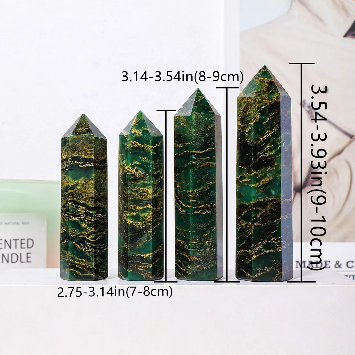 A set of natural emerald crystal point healing wands displayed on a white surface.