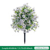 Artificial white petunias with green foliage on a black ground stake