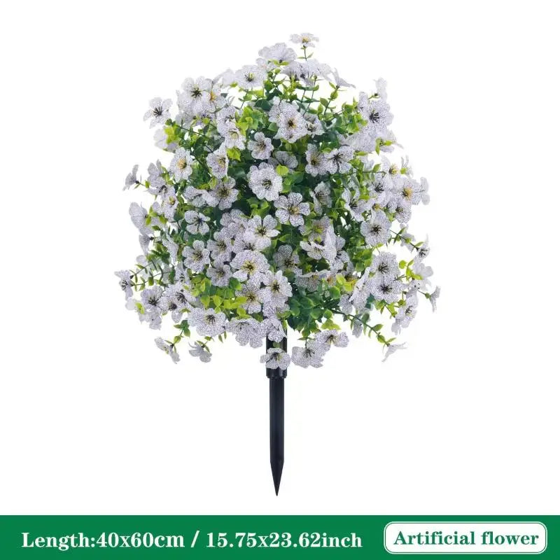 Artificial white petunias with green foliage on a black ground stake
