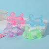 A collection of various colored squishy stress relief toys, including pink, purple, and green balloons, displayed on a white 