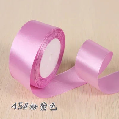 Roll of pink silk satin ribbon for gift wrapping and craft projects