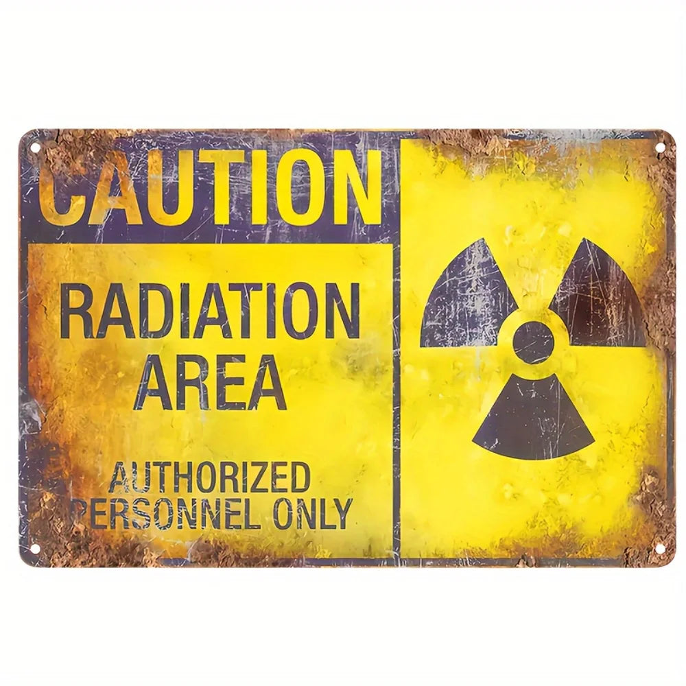A vintage yellow metal sign with black text warning of a radiation area for authorized personnel only.