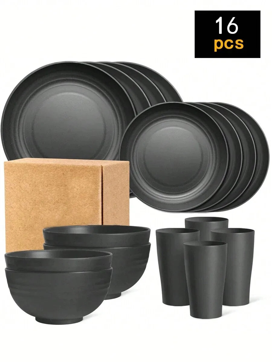 A set of 16 black reusable plastic tableware items including plates, bowls, and cups, packaged in a cardboard box.