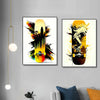 Two framed canvas prints featuring skateboard decks in vibrant yellow and orange against a white background