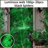 Green glow-in-the-dark spider web decor featuring black spiders on a door background