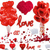A set of heart-shaped balloons in red and pink, along with rose petals and confetti for romantic decorations.