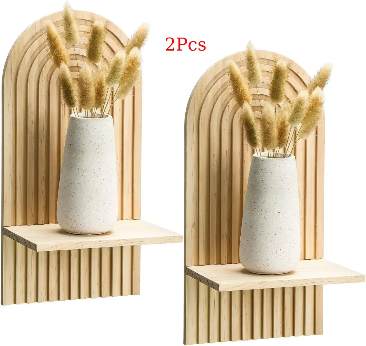 Two pairs of dried ornamental grasses in white ceramic vases displayed on wooden wall shelves