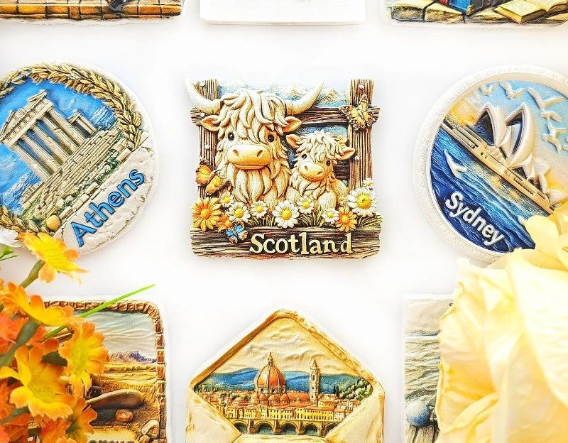 A collection of fridge magnets featuring Scottish Highland cows, Athens, and Sydney.