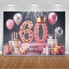 A pink and gold balloon backdrop for a 60th birthday photo booth featuring roses and a crown.