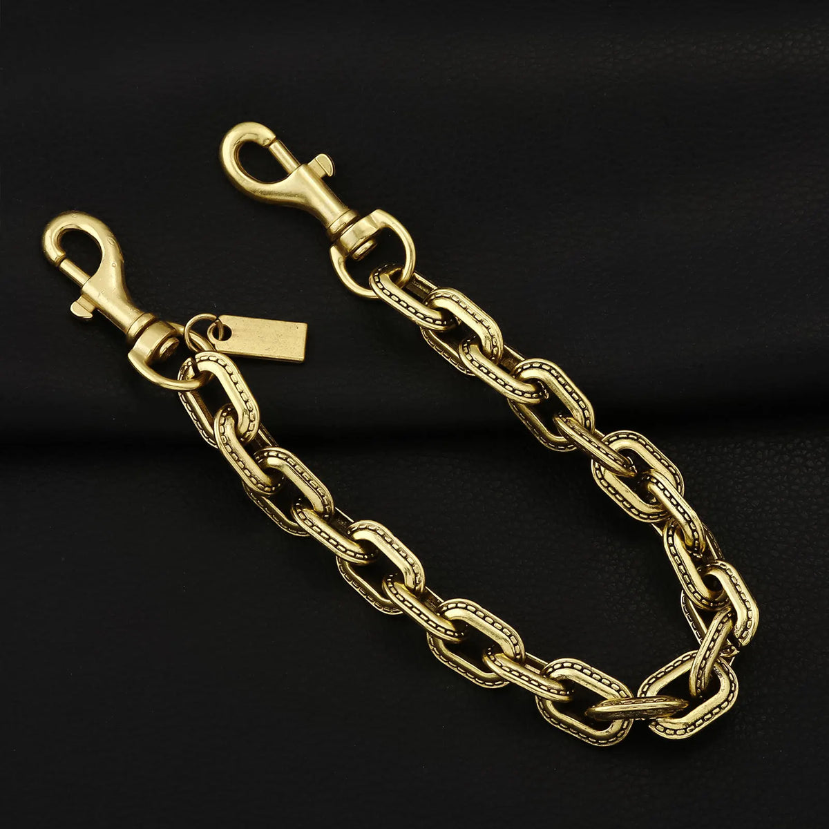 A gold and silver two-tone metal chain necklace with a pendant displayed against a black background.
