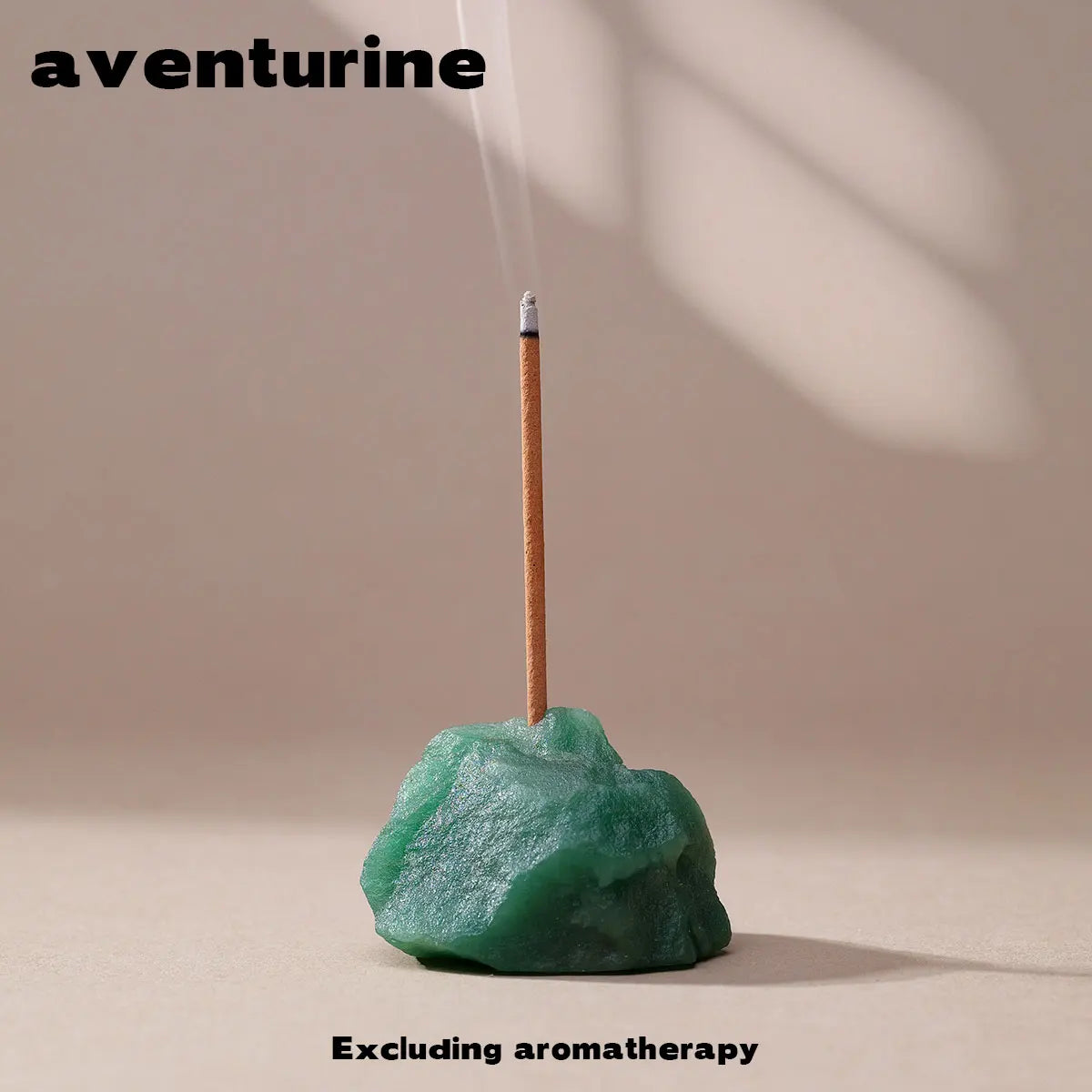 A wooden stick is being lit, producing smoke, above a green crystal on a neutral background.