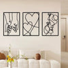 A set of three black line art prints depicting holding hands, a heart, and a profile face on white walls.