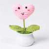 Hand woven pink heart flower in a green pot