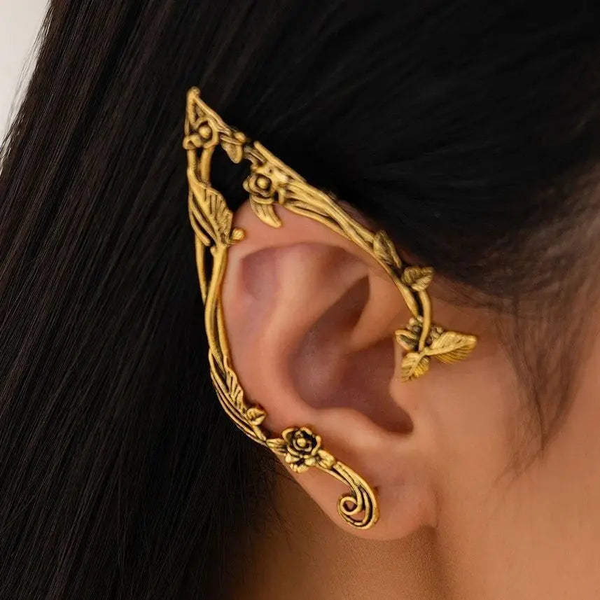 Gold elf flower leaf clip earrings for women worn on an ear.