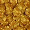 A close-up of golden artificial rose petals used for wedding decoration.