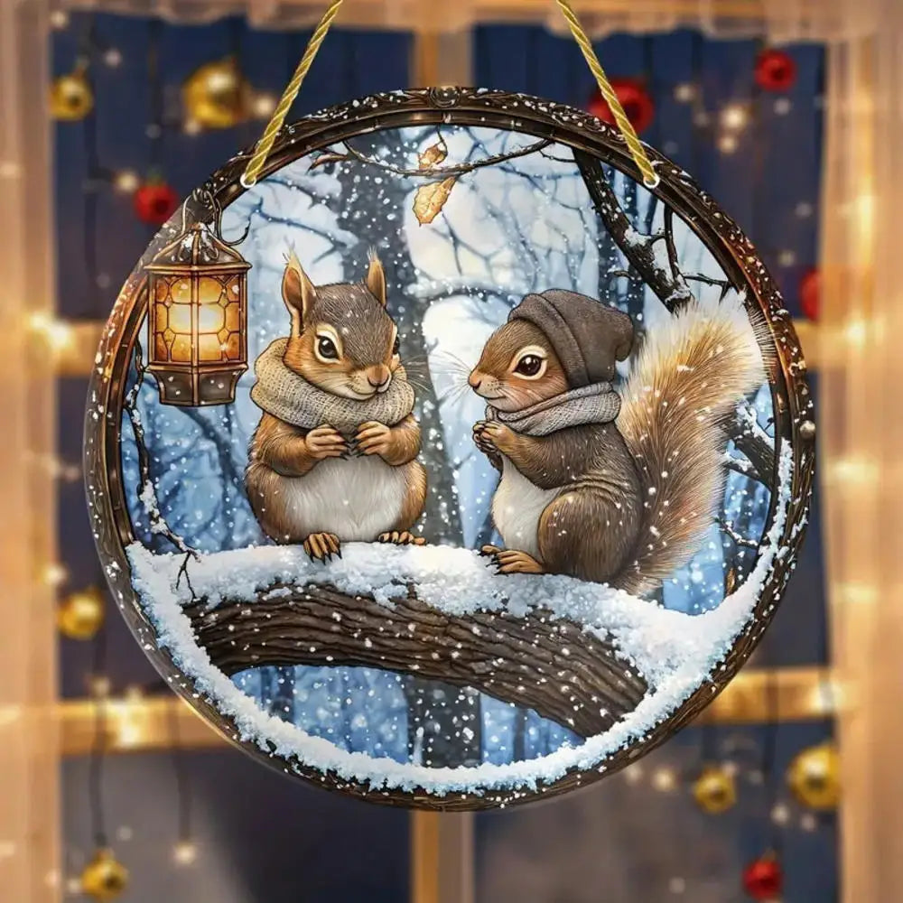 A circular ornament featuring two squirrels in wintery woods with an old-fashioned lantern hanging above them.