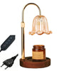 A brass adjustable height aromatherapy candle warmer lamp with a glass shade and a wooden base.