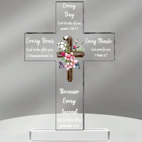 A clear acrylic cross with various Bible verses inscribed on its arms, featuring themes of God's presence and love.
