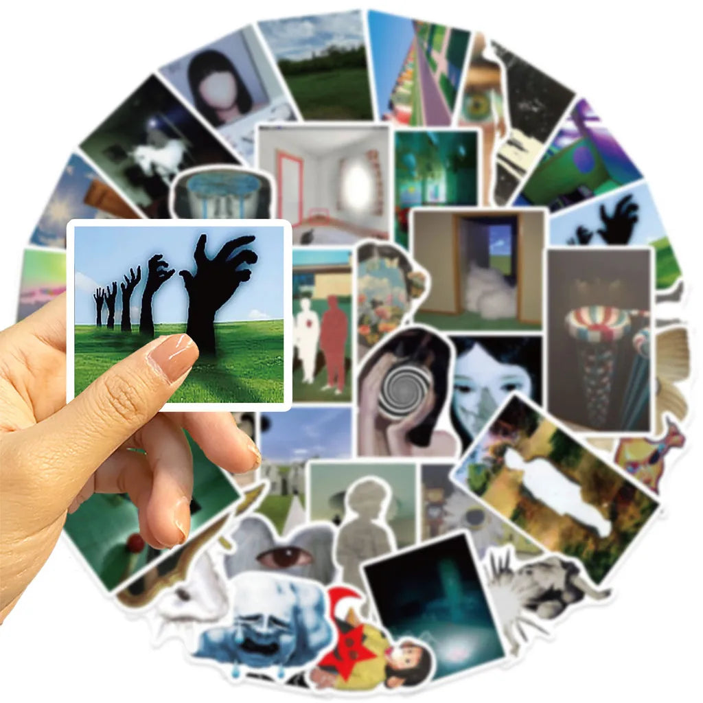 A hand is holding a finger over a collection of colorful aesthetic dreamcore graffiti stickers.