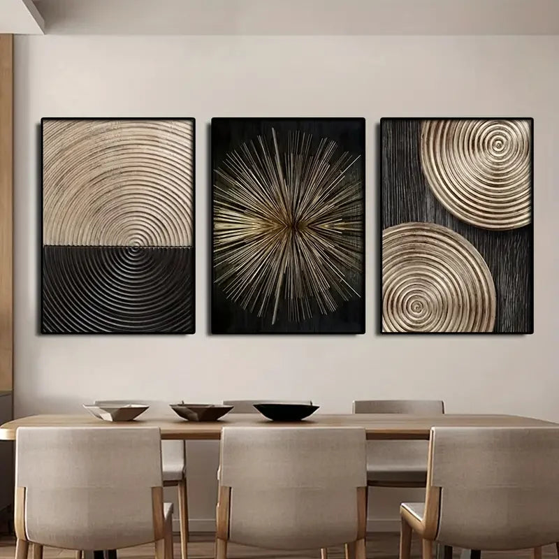 A set of three abstract canvas prints featuring concentric circle patterns in gold and black tones displayed on a light wall.