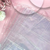 Una pila de hojas de archivador de photocards Kpop A4 en tonos rosa suave y lila con detalles florales.