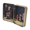 A tin box depicting a nativity scene with hand-painted figures and gold trim.