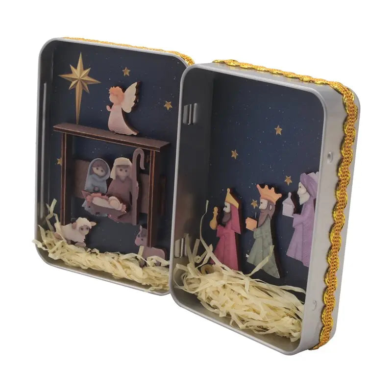 A tin box depicting a nativity scene with hand-painted figures and gold trim.