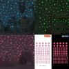 A set of glow-in-the-dark star wall decals featuring green and blue stars on a wall.