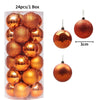 A box containing 24 gold and copper-colored festive Christmas tree ornament balls.