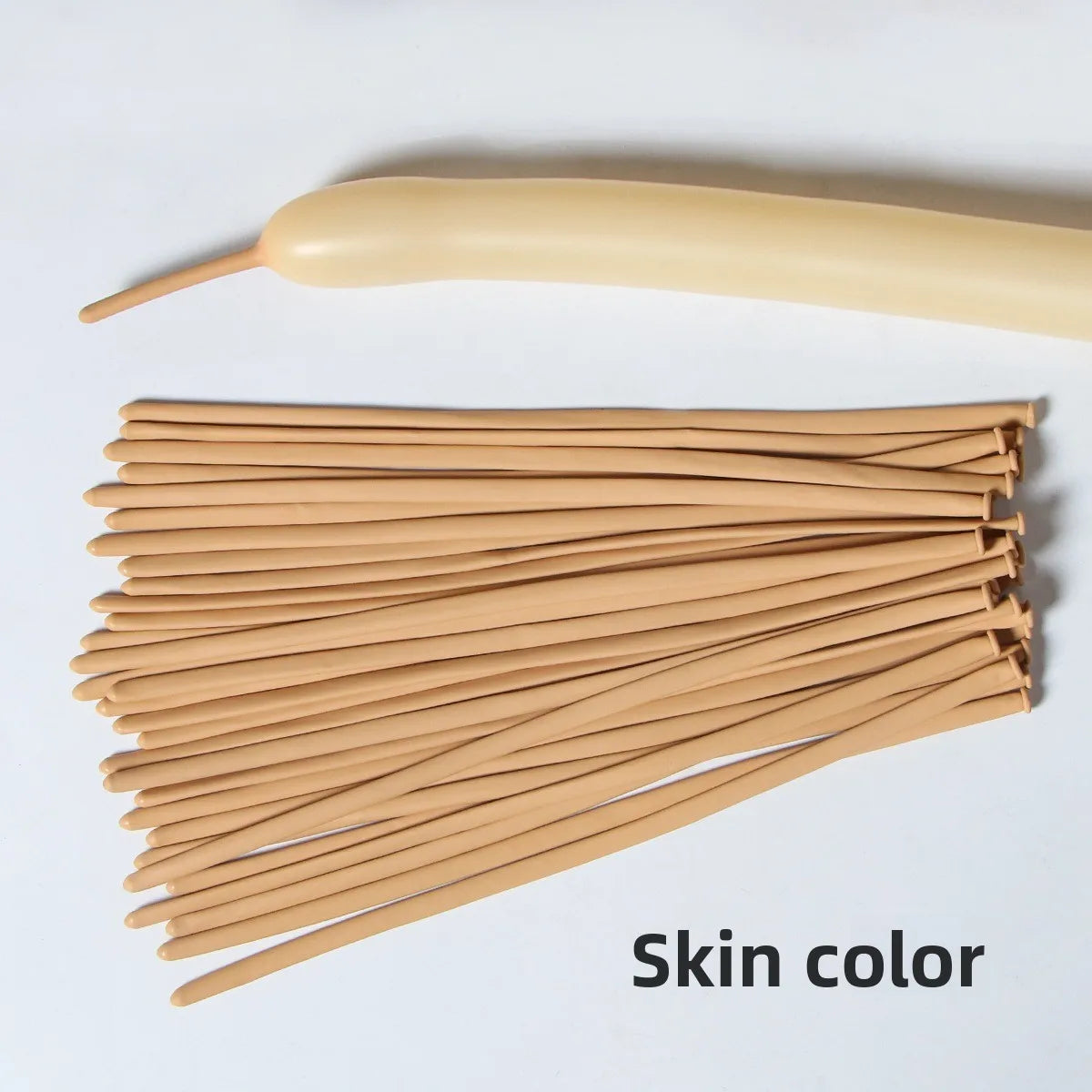 A bundle of tan latex strip balloons and a yellow balloon nozzle for party decoration.