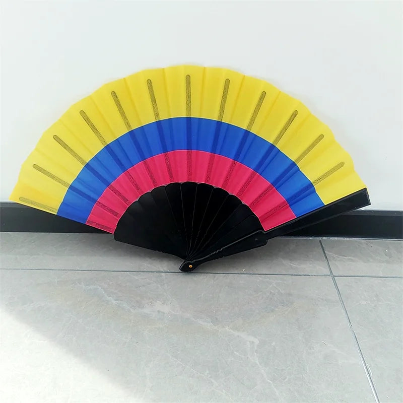A handheld folding fan with a rainbow design featuring yellow, blue, and pink stripes.