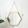 A hexagonal wall mirror with a gold frame and a chain hanger, shown against a white background.
