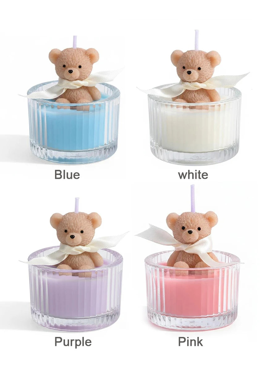 Four soy wax teddy bear candles in glass jars featuring blue, white, purple, and pink colors with ribbons