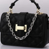 Black quilted handbag with a gold-toned metal chain strap and pendant