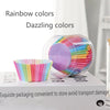 A clear plastic container filled with rainbow colored disposable cupcake liners.