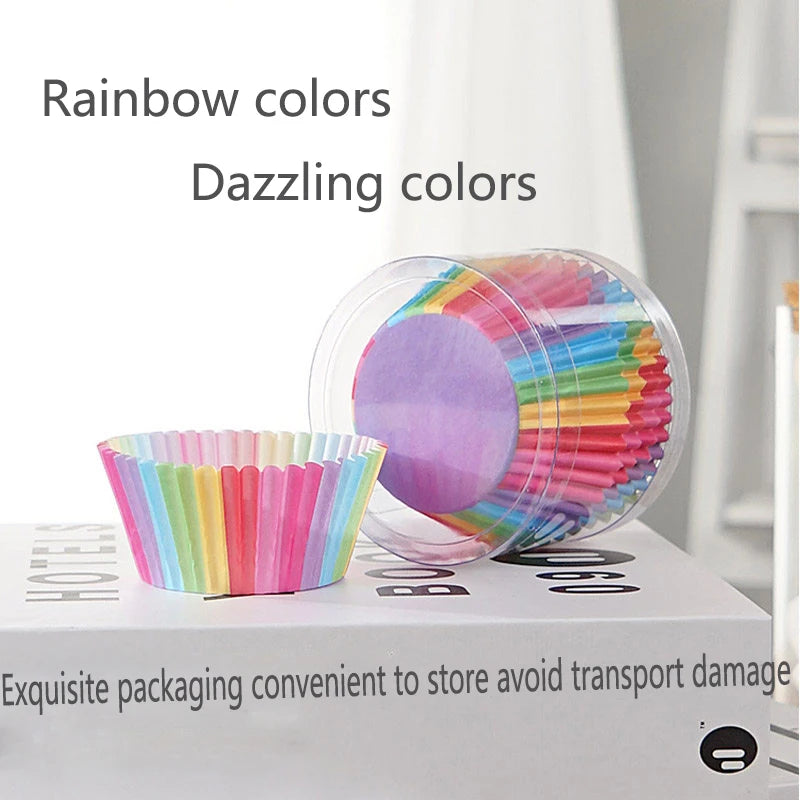 A clear plastic container filled with rainbow colored disposable cupcake liners.