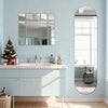 A bathroom vanity with a white sink and light blue walls featuring a large oval mirror.