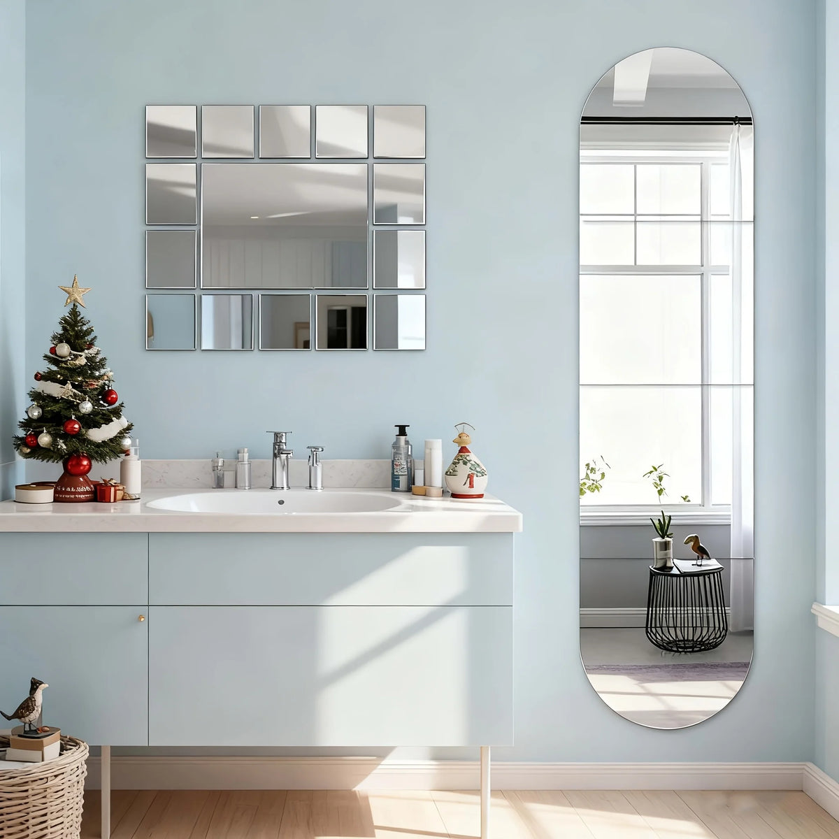 A bathroom vanity with a white sink and light blue walls featuring a large oval mirror.