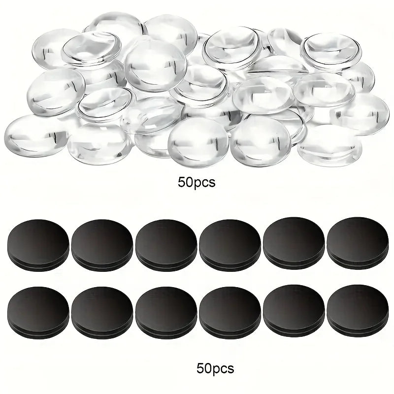 A collection of clear, round decorative refrigerator magnets and black circular magnets for custom crafts.