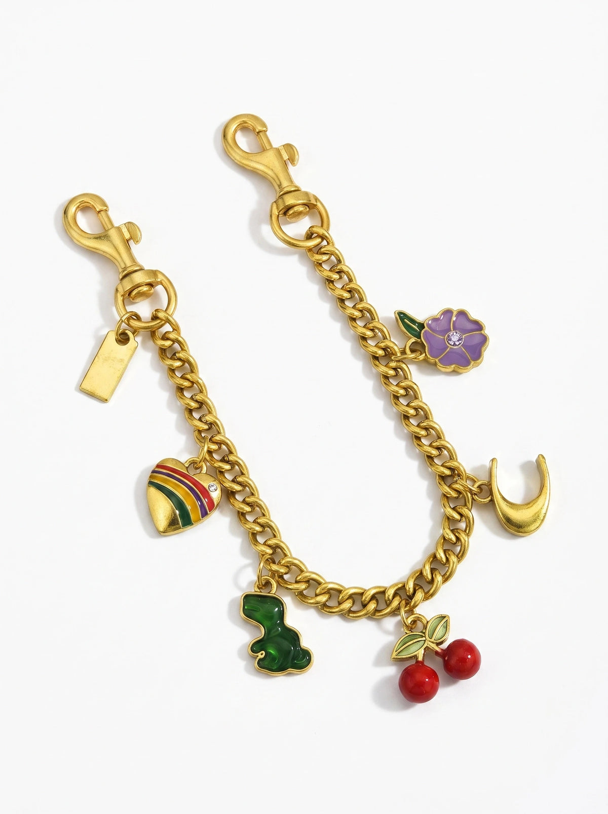 Collier en chaîne doré avec un charm de fleur violette et feuille verte.