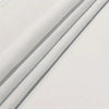 Close-up of a light gray decorative fabric wall tapestry showing folds and texture.